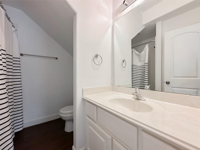 full bath featuring baseboards, toilet, lofted ceiling, wood finished floors, and vanity