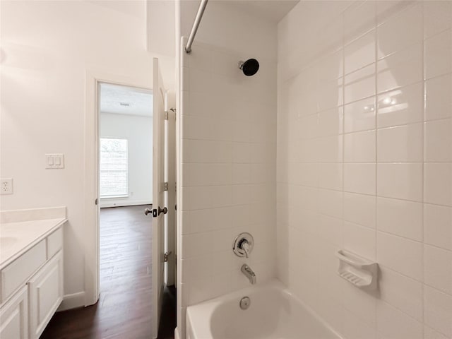 full bath featuring wood finished floors, shower / washtub combination, and vanity