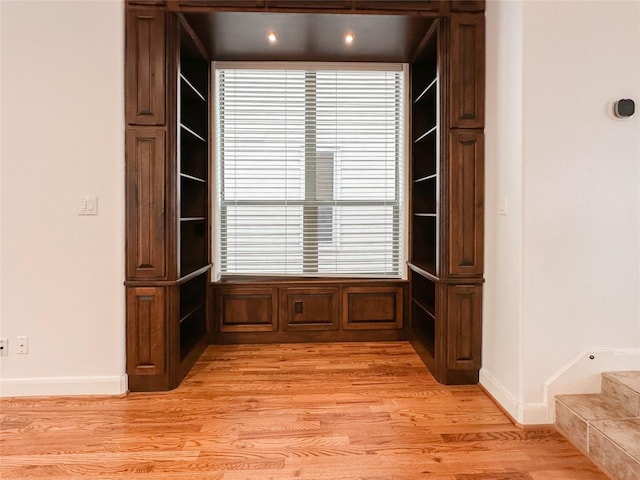 interior space featuring wood finished floors and baseboards