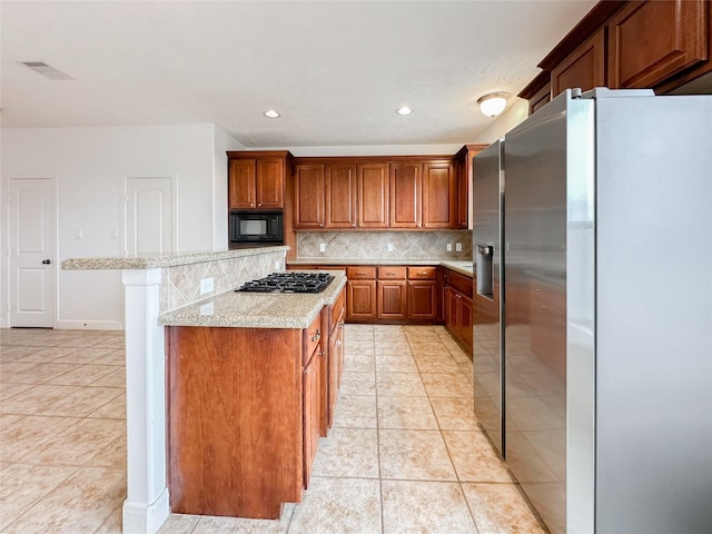 kitchen featuring light tile patterned floors, black microwave, tasteful backsplash, and stainless steel refrigerator with ice dispenser