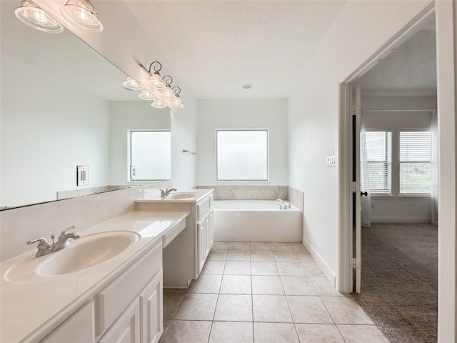 bathroom featuring tile patterned flooring, double vanity, a garden tub, and a sink