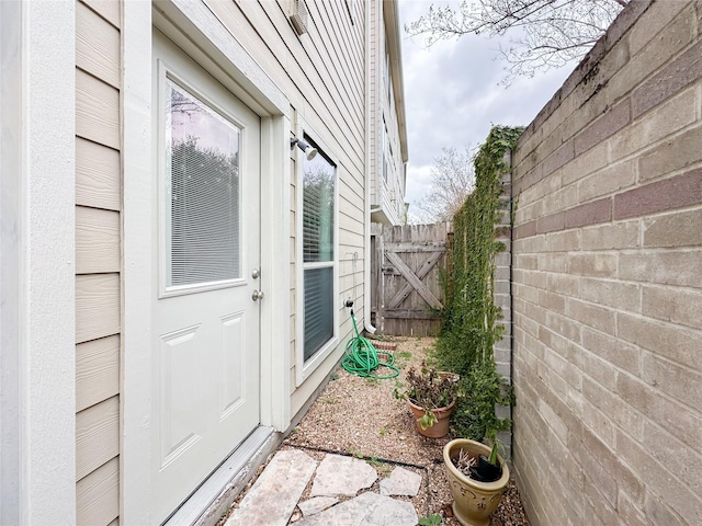 view of exterior entry featuring fence