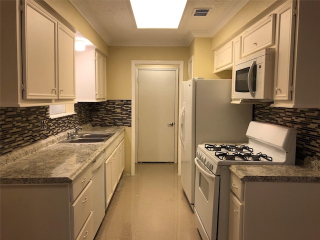 kitchen with a sink, backsplash, white appliances, crown molding, and light tile patterned floors