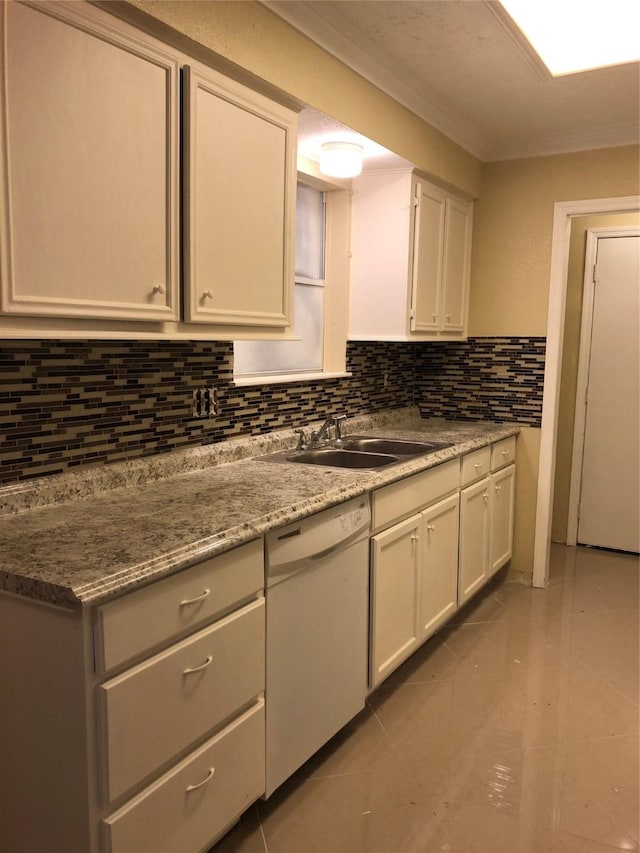 kitchen featuring light tile patterned floors, decorative backsplash, white dishwasher, white cabinets, and a sink