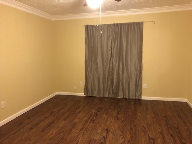 spare room featuring baseboards, dark wood-type flooring, a ceiling fan, and ornamental molding