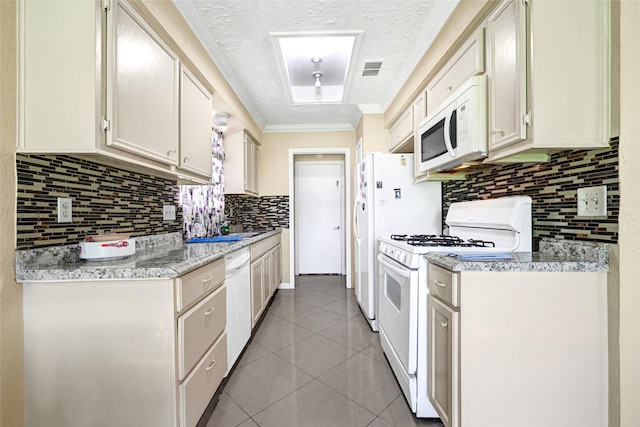 8639 Pearl Point St, Houston, TX 77044 - kitchen featuring white appliances, backsplash, light countertops, light tile patterned floors, and crown molding