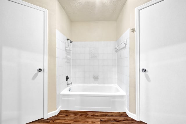 8639 Pearl Point St, Houston, TX 77044 - bathroom featuring a textured ceiling, bathing tub / shower combination, and wood finished floors
