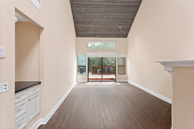 148 Sugarberry Cir, Houston, TX 77024 - unfurnished living room featuring high vaulted ceiling, baseboards, wood ceiling, and dark wood-style flooring