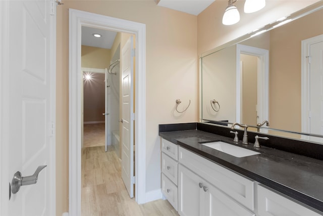 148 Sugarberry Cir, Houston, TX 77024 - bathroom featuring vanity, baseboards, and wood finished floors