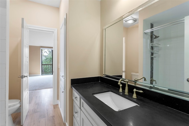 148 Sugarberry Cir, Houston, TX 77024 - bathroom with vanity, walk in shower, wood finished floors, and toilet