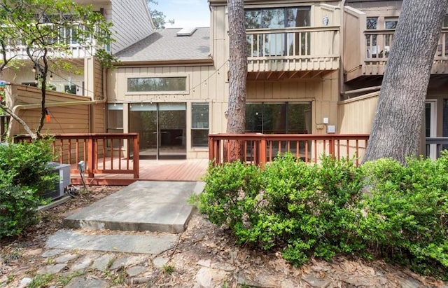 148 Sugarberry Cir, Houston, TX 77024 - back of house featuring a shingled roof and a deck