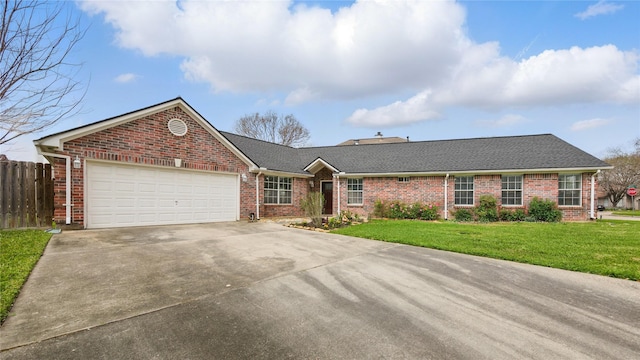 single story home featuring brick siding, fence, concrete driveway, a front yard, and a garage