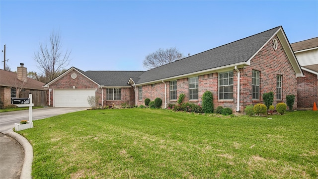 single story home with brick siding, an attached garage, concrete driveway, and a front yard