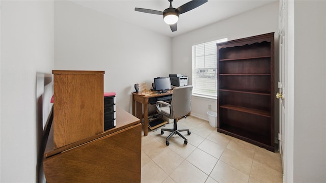 home office with light tile patterned flooring, baseboards, and a ceiling fan