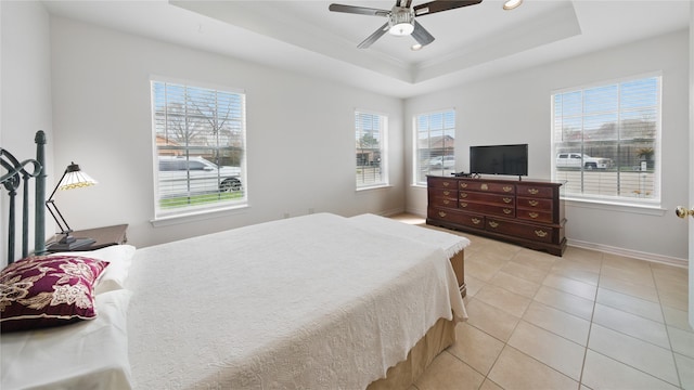 bedroom with light tile patterned floors, a ceiling fan, baseboards, a tray ceiling, and recessed lighting