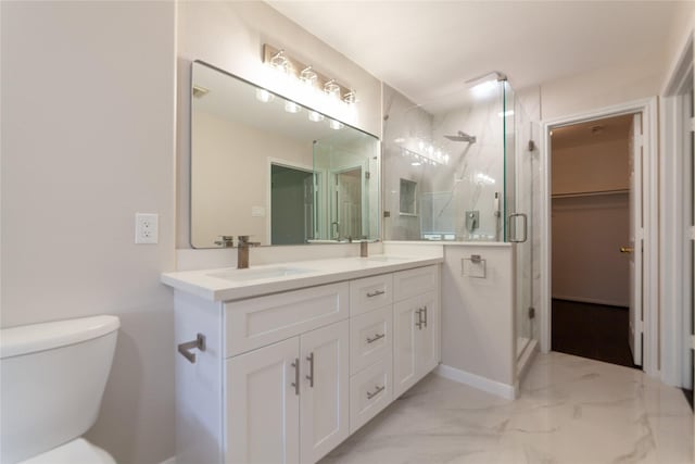 full bath with a shower stall, toilet, marble finish floor, and a sink