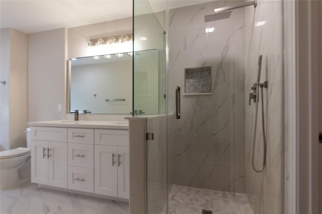 full bath featuring toilet, marble finish floor, a sink, a marble finish shower, and double vanity