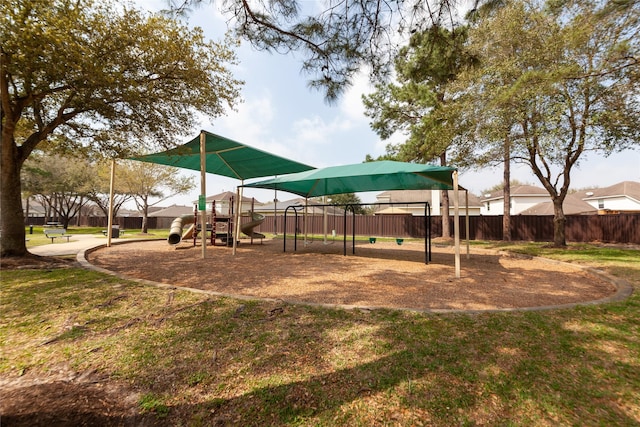 communal playground with a lawn and fence