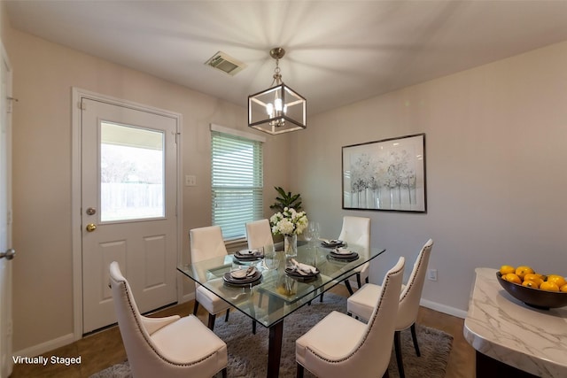 dining room with visible vents, baseboards, and a chandelier