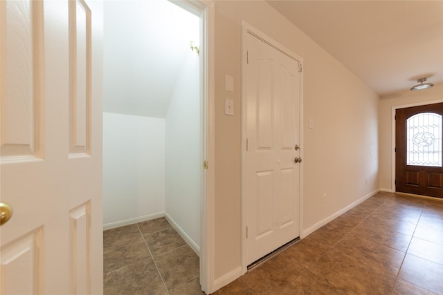 entryway featuring vaulted ceiling and baseboards