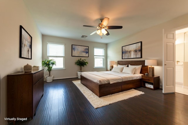 bedroom with dark wood-style floors, visible vents, and ceiling fan