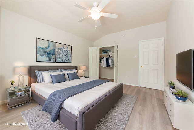 bedroom with baseboards, light wood-style floors, and vaulted ceiling