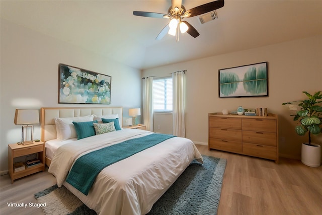 bedroom with visible vents, a ceiling fan, light wood-type flooring, and baseboards