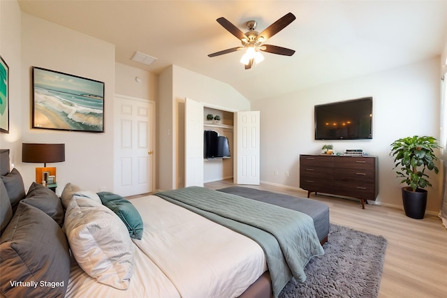 bedroom with visible vents, baseboards, light wood-type flooring, lofted ceiling, and a ceiling fan