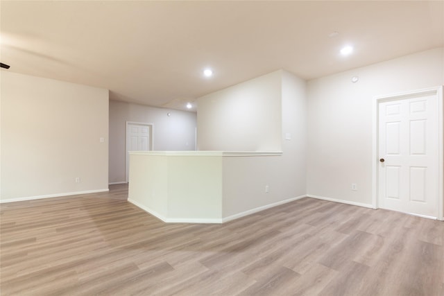 empty room with recessed lighting, baseboards, and light wood finished floors