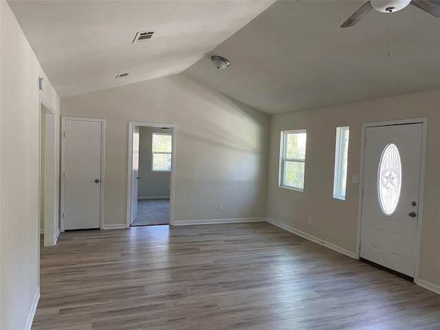 entryway with a wealth of natural light, visible vents, and light wood-style flooring