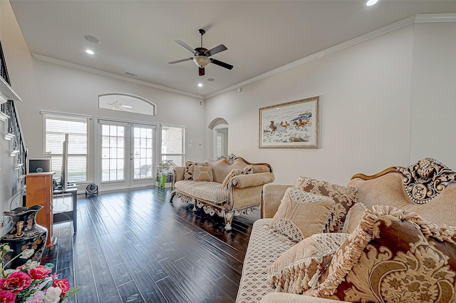 living area with ceiling fan, wood finished floors, arched walkways, recessed lighting, and ornamental molding