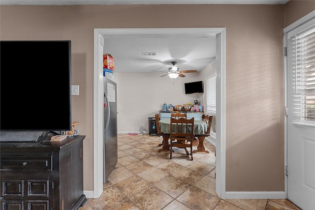 interior space featuring visible vents, baseboards, and a ceiling fan