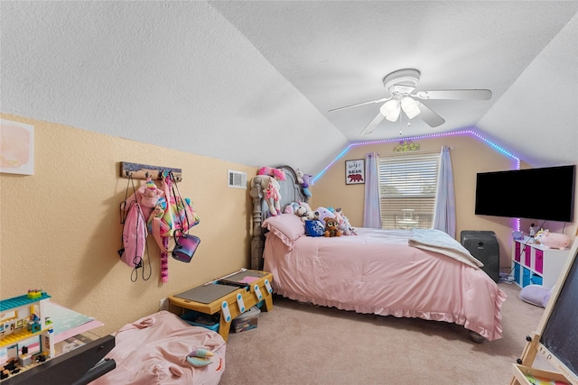 carpeted bedroom with visible vents, ceiling fan, vaulted ceiling, a textured ceiling, and a textured wall