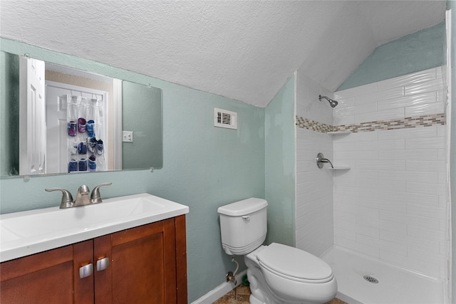 bathroom featuring visible vents, tiled shower, lofted ceiling, a textured ceiling, and toilet