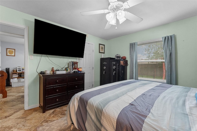 bedroom featuring baseboards and ceiling fan