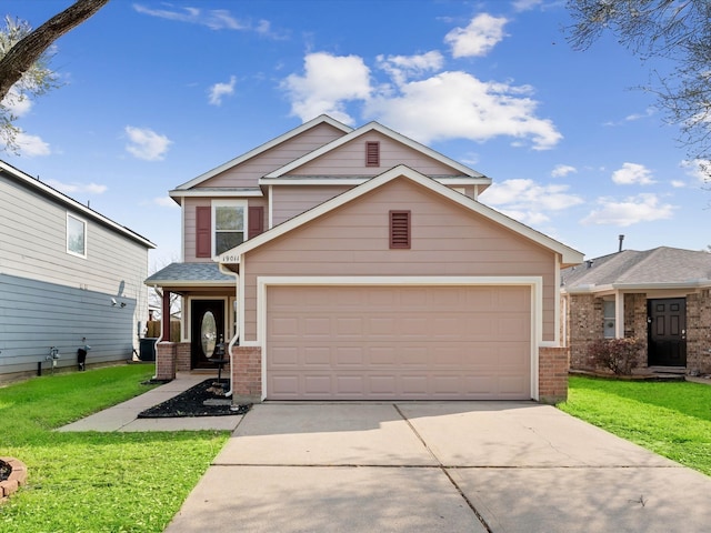 view of front of home with brick siding, driveway, an attached garage, and a front lawn