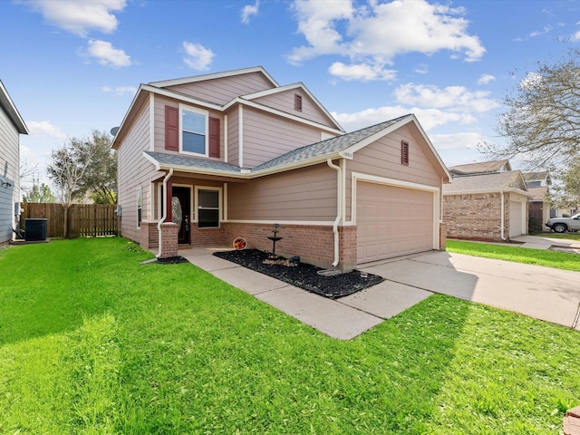 traditional-style home with fence, an attached garage, a front lawn, concrete driveway, and brick siding