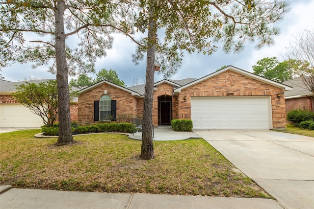 ranch-style home featuring concrete driveway, an attached garage, brick siding, and a front yard