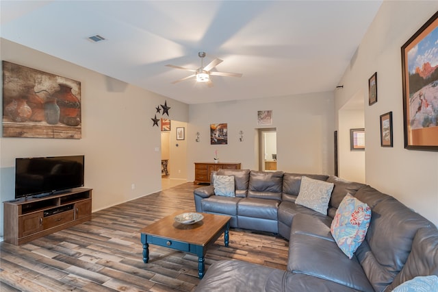 living area featuring visible vents, a ceiling fan, and wood finished floors