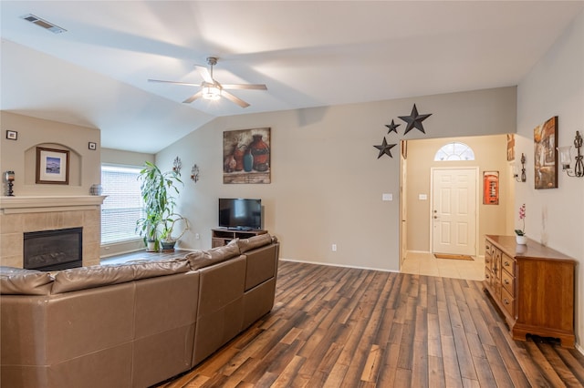 living room featuring visible vents, a ceiling fan, wood finished floors, a fireplace, and lofted ceiling