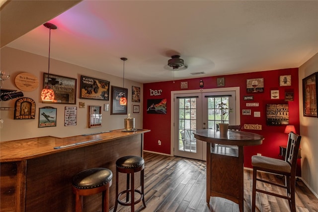 bar with visible vents, baseboards, dark wood-style flooring, ceiling fan, and french doors