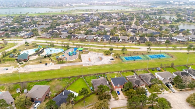 drone / aerial view featuring a residential view and a water view