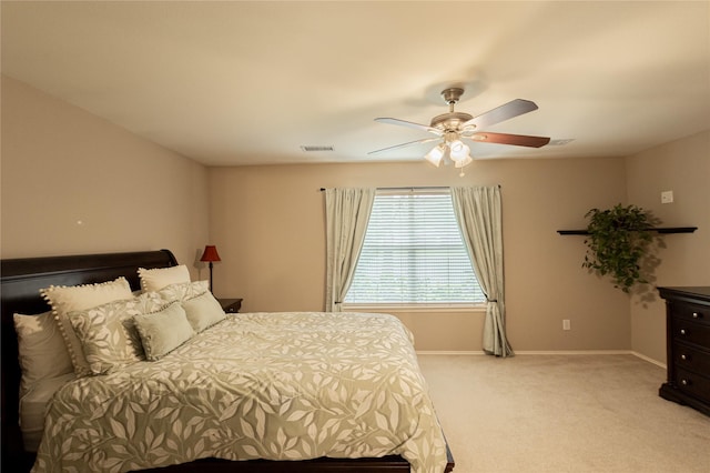 bedroom featuring a ceiling fan, visible vents, light colored carpet, and baseboards