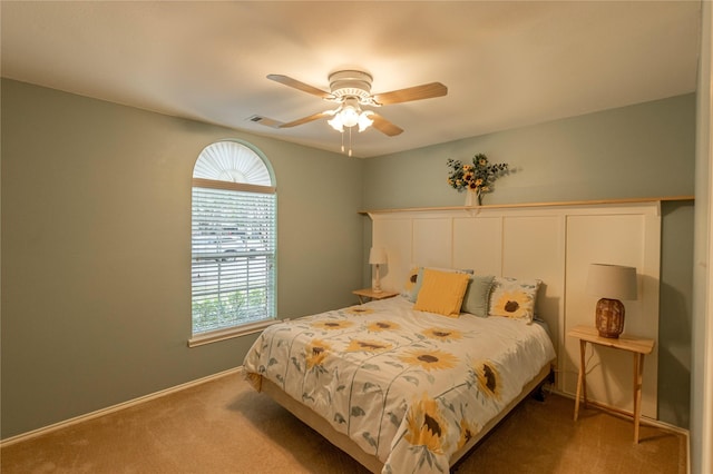 bedroom featuring visible vents, multiple windows, baseboards, and carpet