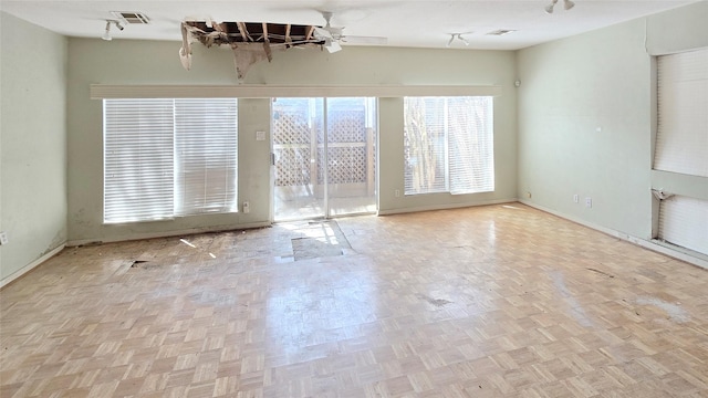 unfurnished room featuring visible vents, baseboards, and ceiling fan