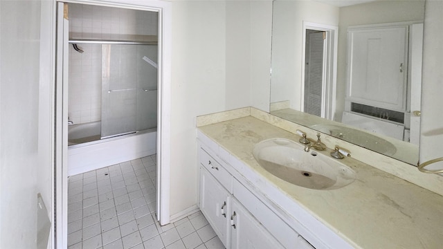 bathroom featuring vanity, tile patterned floors, and combined bath / shower with glass door