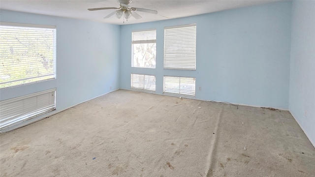 unfurnished room with carpet flooring and ceiling fan