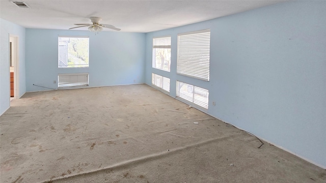 spare room with visible vents, ceiling fan, and carpet floors