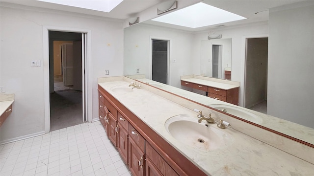 full bathroom with a sink, a skylight, and double vanity