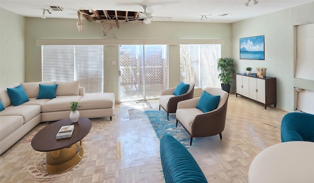 living room featuring visible vents, ceiling fan, and track lighting